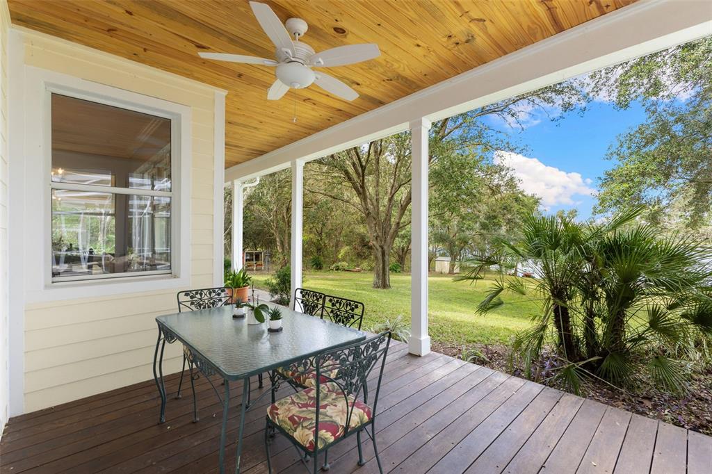 18725 South Obrien Road Groveland, FL 34736 - Photo 13 of 68 a view of a porch with furniture and wooden floor