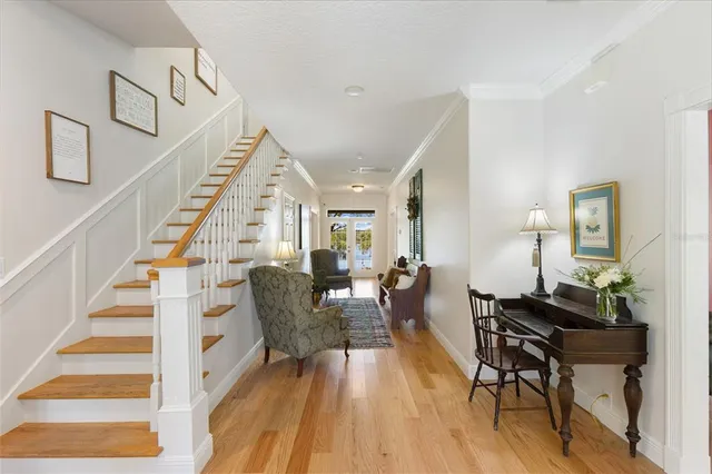 a living room with furniture ceiling fan and a window