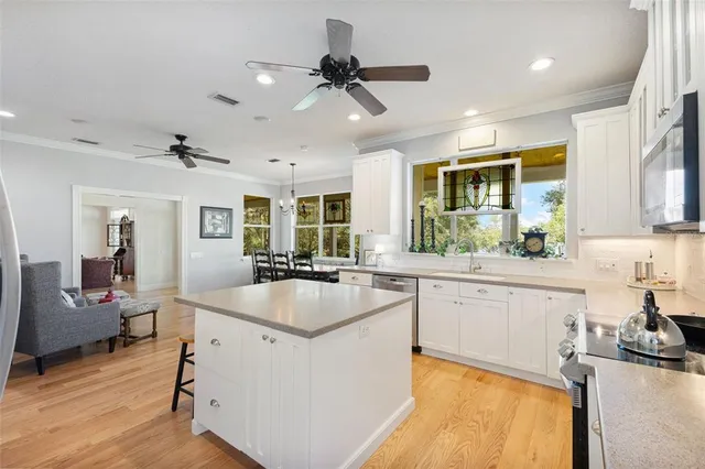a living room with furniture floor to ceiling window and a table