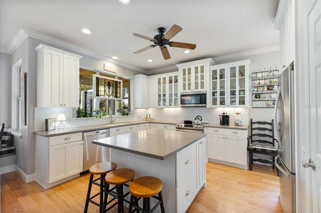 18725 South Obrien Road Groveland, FL 34736 - Photo 33 of 68 a kitchen with stainless steel appliances granite countertop a sink a stove and a refrigerator