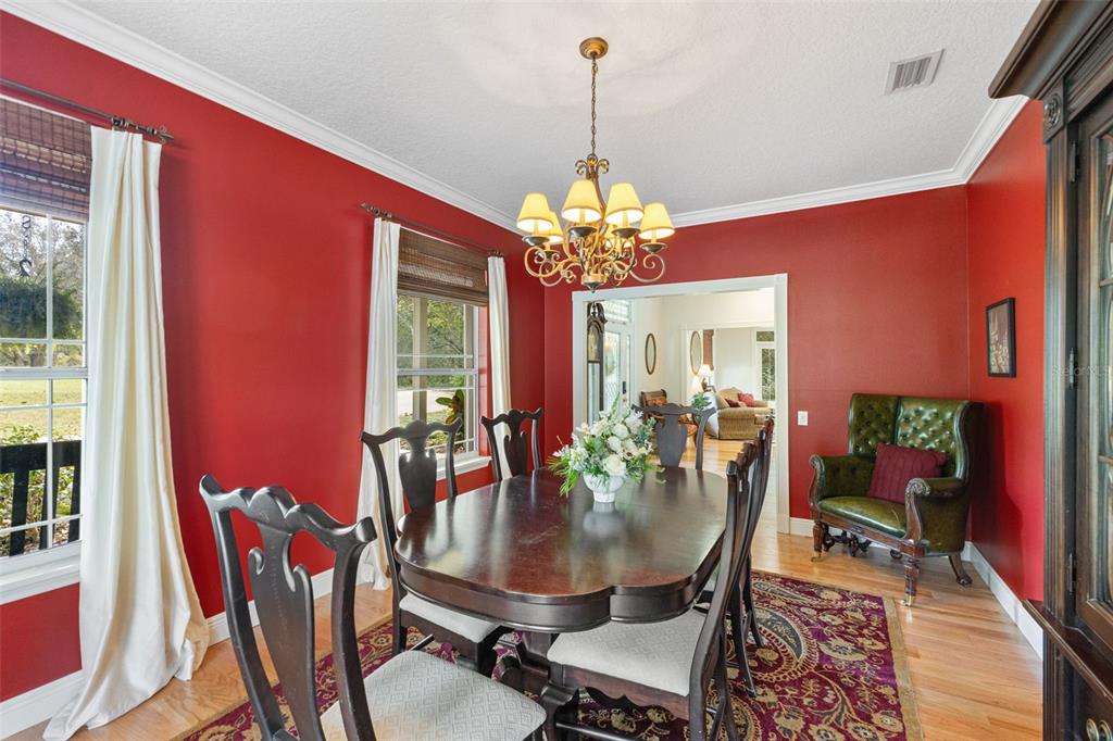 18725 South Obrien Road Groveland, FL 34736 - Photo 38 of 68 a dining room with furniture a chandelier and wooden floor