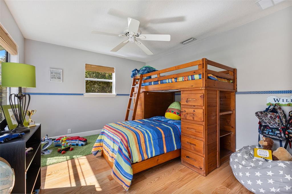 18725 South Obrien Road Groveland, FL 34736 - Photo 50 of 68 a bedroom with a bed and wooden floor