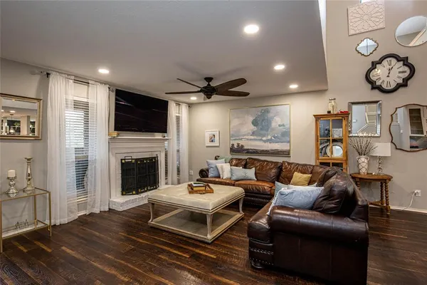a living room with furniture a fireplace and a flat screen tv