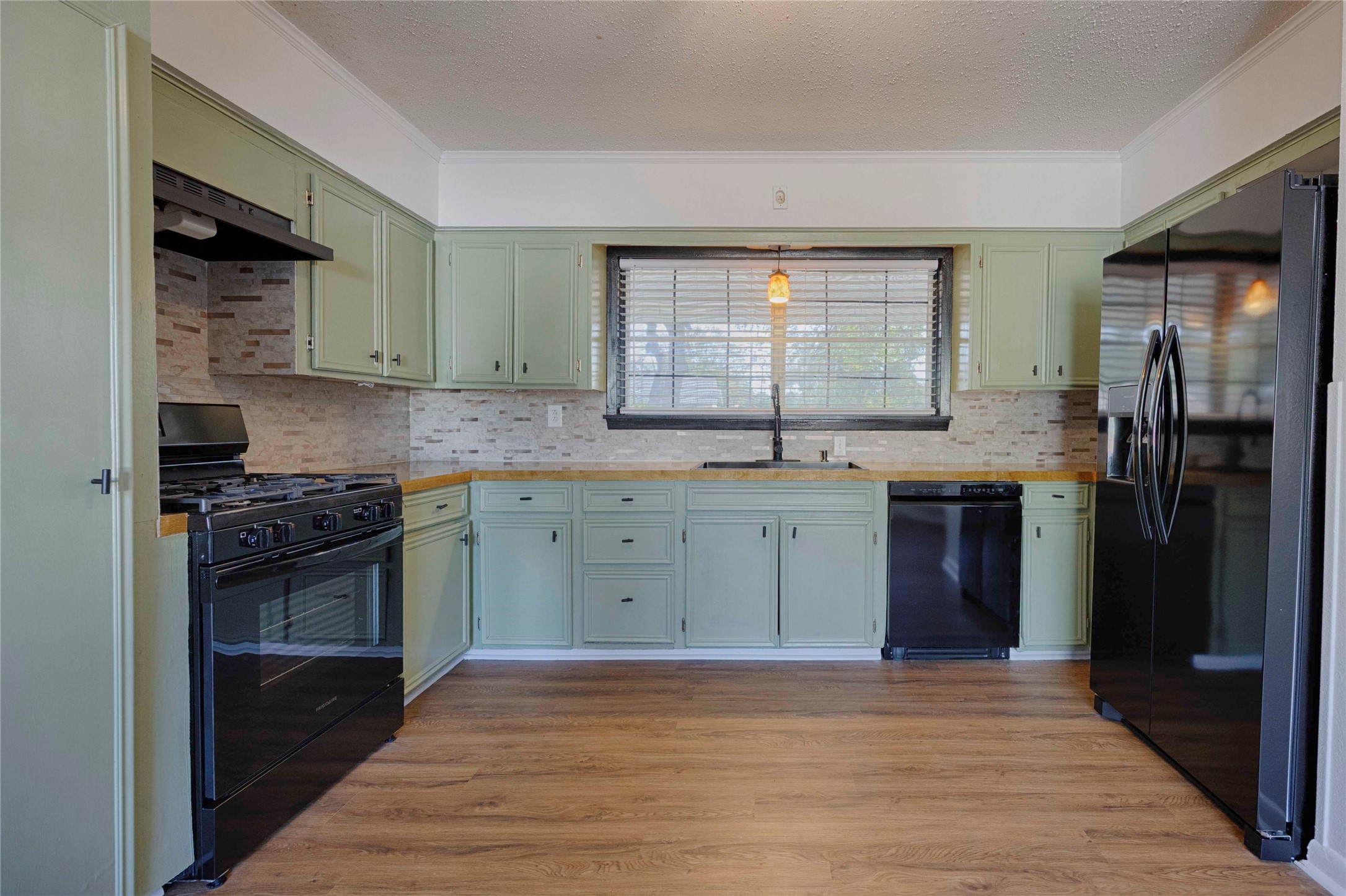 909 Eilers Street Schulenburg, TX 78956 - Photo 11 of 33 a kitchen with a sink stove and refrigerator