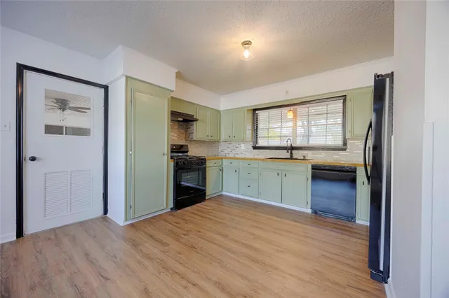 a kitchen with a refrigerator and a sink