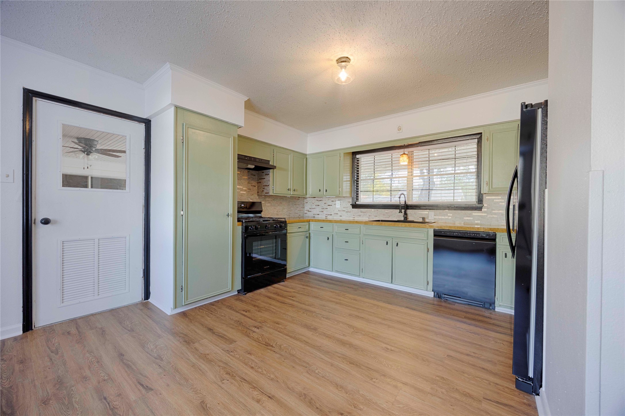 909 Eilers Street Schulenburg, TX 78956 - Photo 12 of 33 a kitchen with a refrigerator and a sink