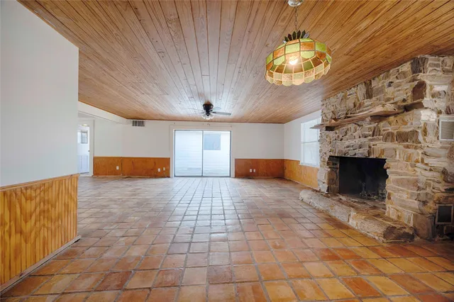 a view of empty room with a fireplace