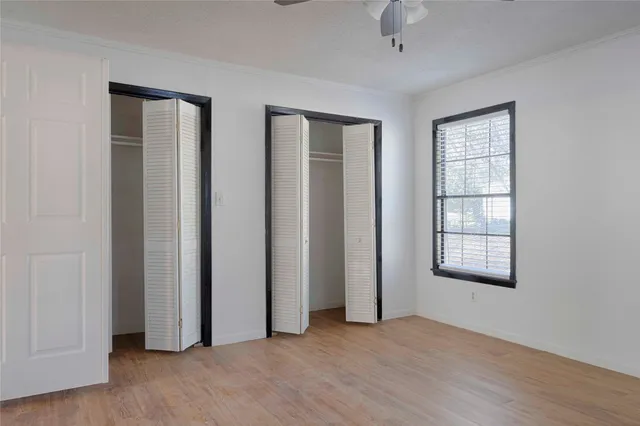 an empty room with windows and closet