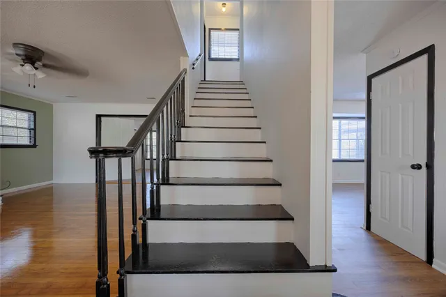 a view of entryway and hall with wooden floor