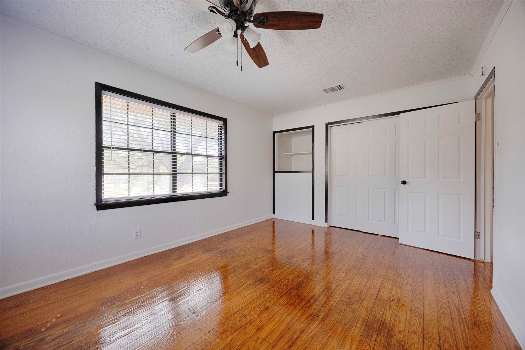 909 Eilers Street Schulenburg, TX 78956 - Photo 25 of 33 a view of an empty room with wooden floor and a window