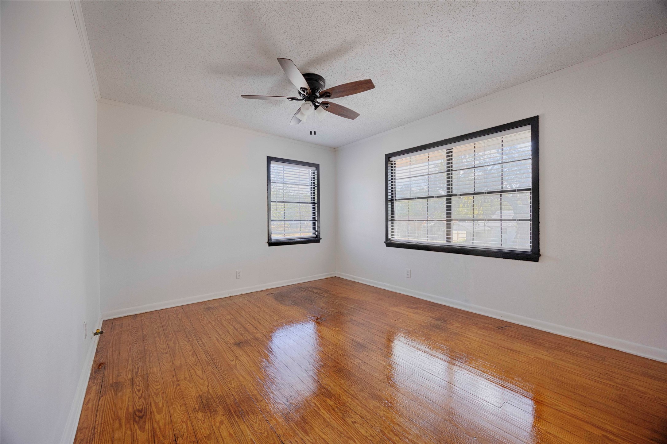 909 Eilers Street Schulenburg, TX 78956 - Photo 26 of 33 wooden floor in an empty room with a window