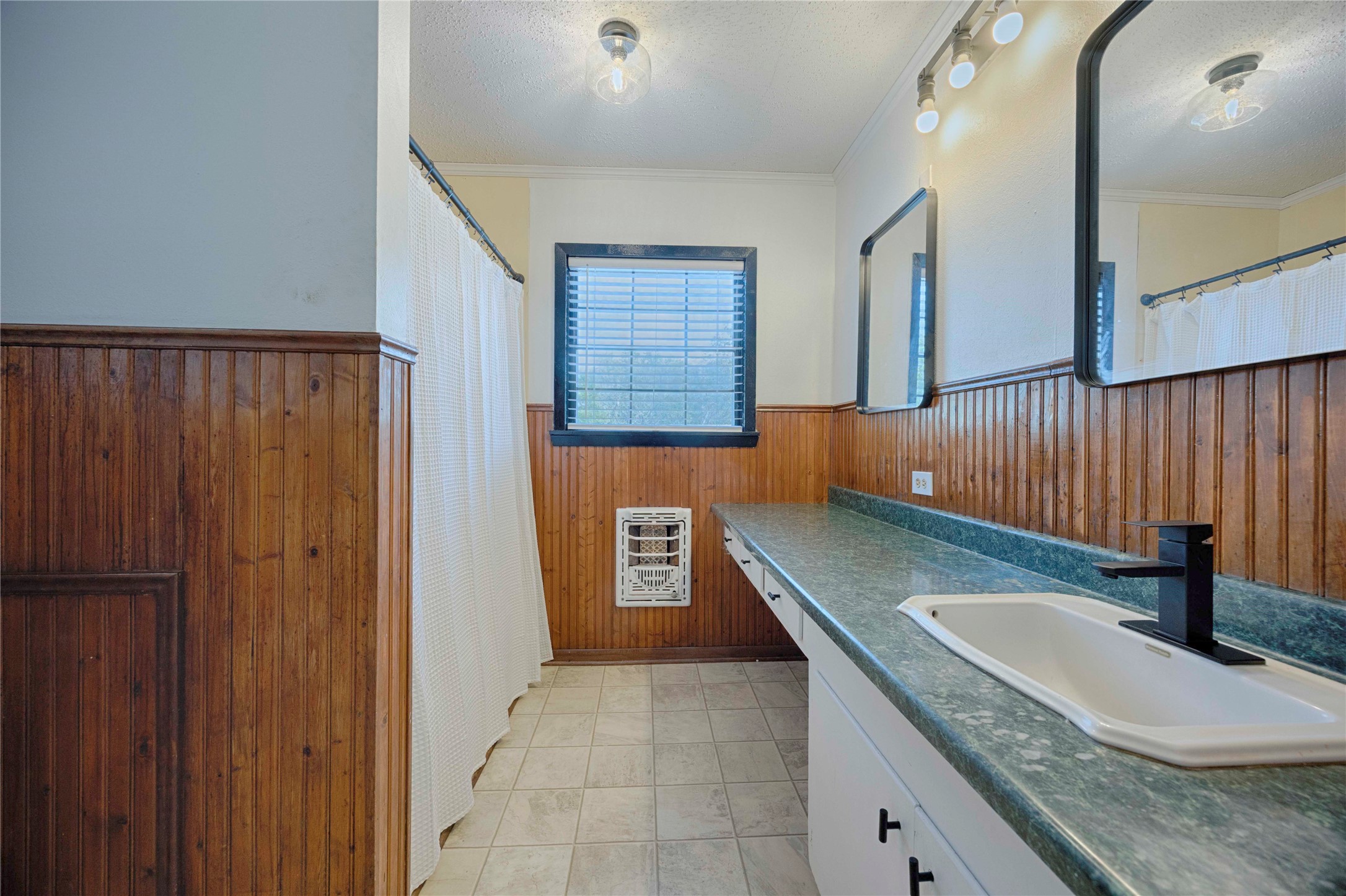 909 Eilers Street Schulenburg, TX 78956 - Photo 27 of 33 a bathroom with a granite countertop sink and a mirror