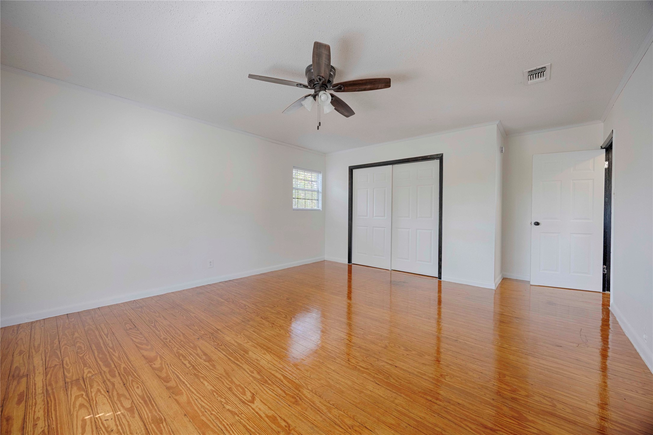 909 Eilers Street Schulenburg, TX 78956 - Photo 30 of 33 a view of an empty room with wooden floor and a ceiling fan