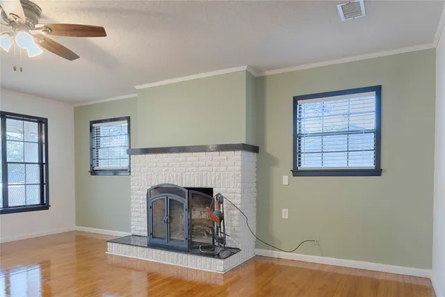 a living room with fireplace furniture and a window
