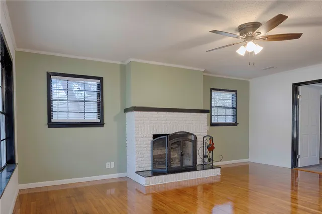 a living room with fireplace and a wooden floor