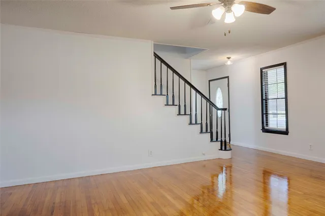 wooden floor in an empty room with a window