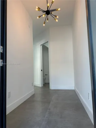 an empty room and chandelier fan view