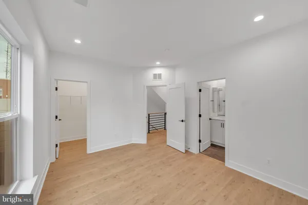 a view of entryway with wooden floor and a front door