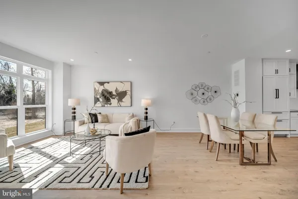 a living room with furniture and view of kitchen