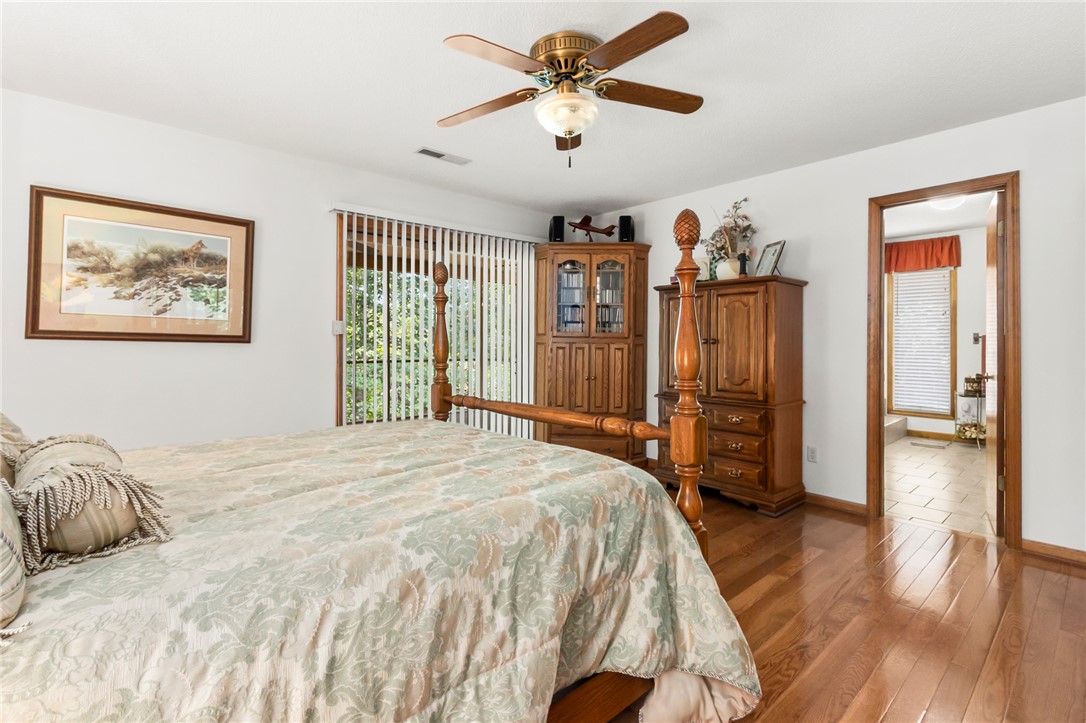 202 Plantation Point Anderson, SC 29625 - Photo 25 of 48 Hardwood floors and a ceiling fan enhance this cozy bedroom with natural light through sliding glass doors.