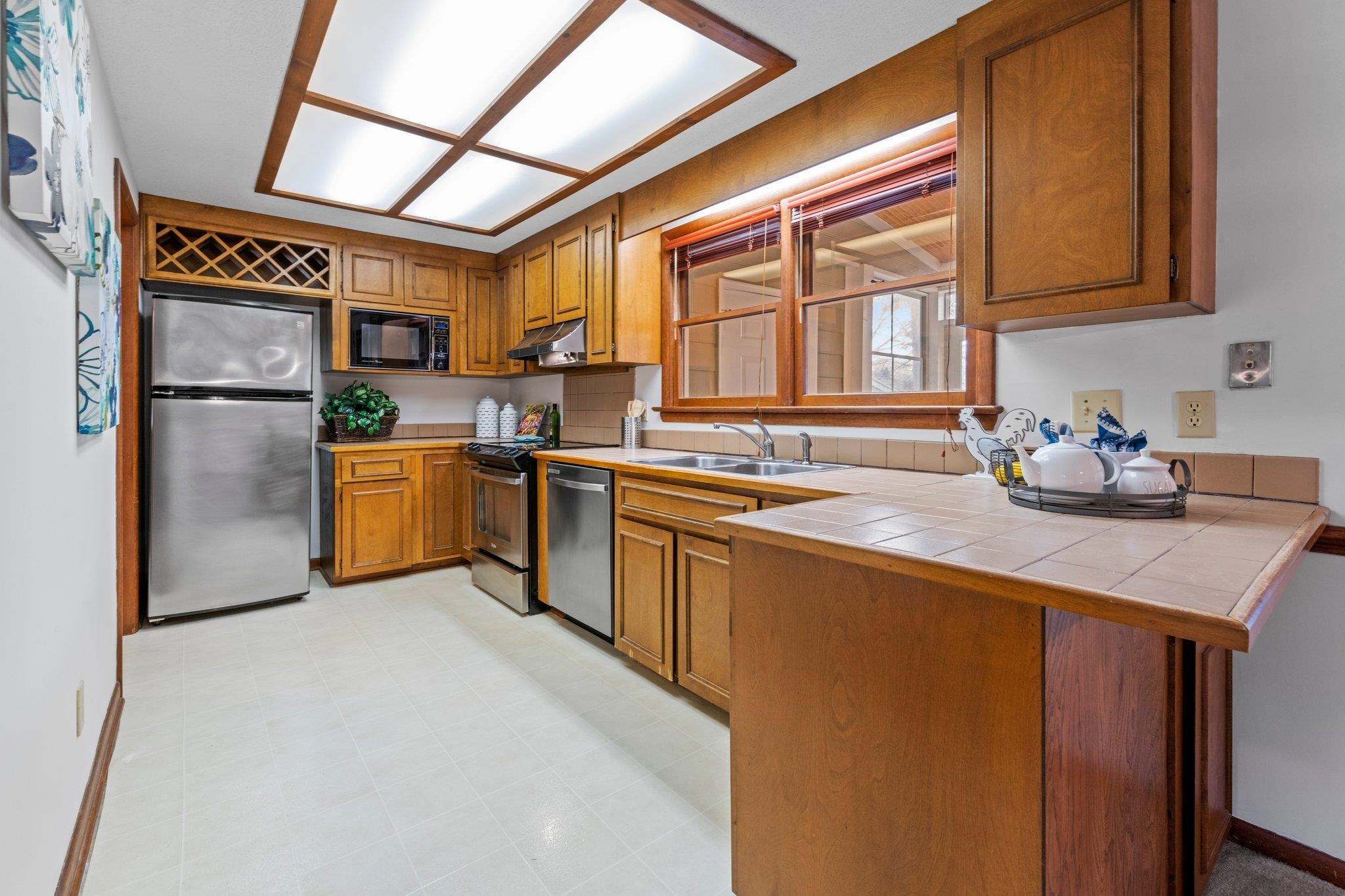 7829 Breckon Way Raleigh, NC 27615 - Photo 10 of 40 Kitchen with SS appliances aside from MW, large double window looking out into porch and pond views. Kitchen