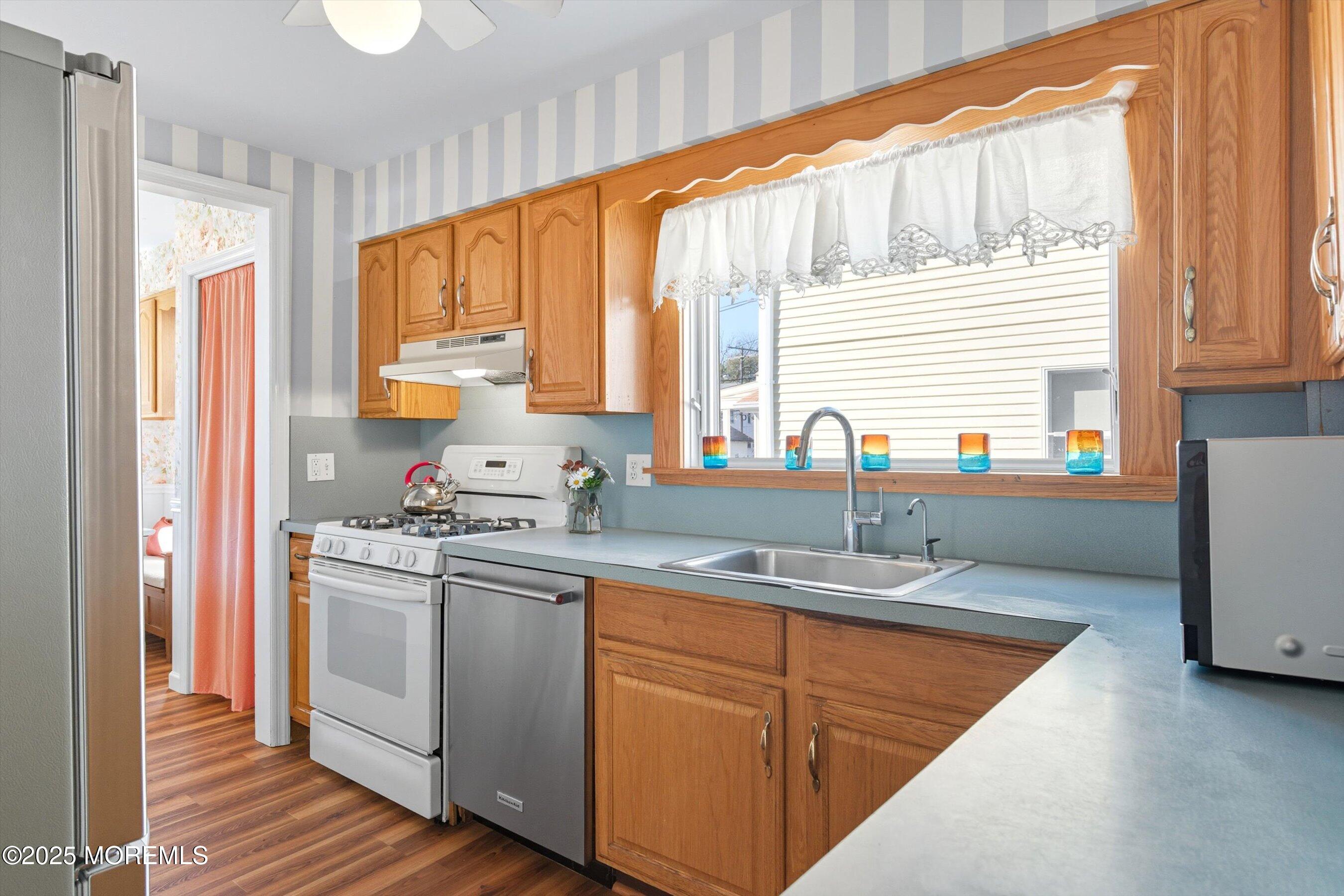 425 Washington Avenue Avon-by-the-Sea, NJ 07717 - Photo 13 of 41 a kitchen with stainless steel appliances granite countertop a sink a stove and a refrigerator