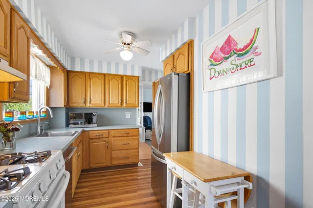 a kitchen with a refrigerator and a stove