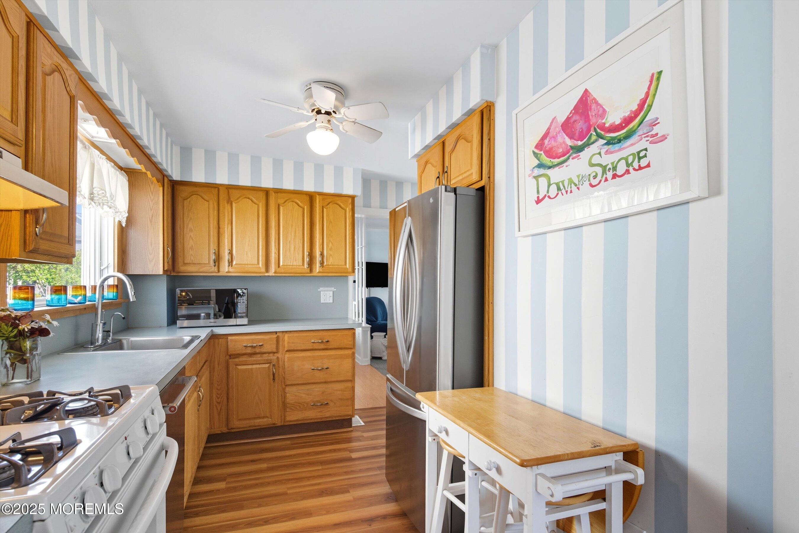 425 Washington Avenue Avon-by-the-Sea, NJ 07717 - Photo 14 of 41 a kitchen with a refrigerator and a stove