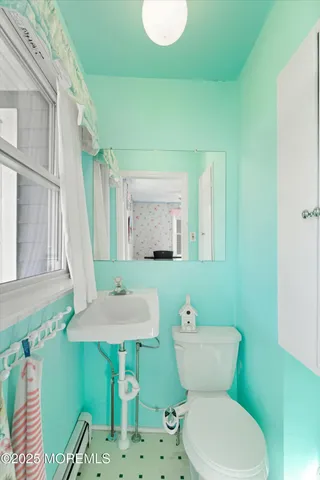 a bathroom with a toilet sink and mirror