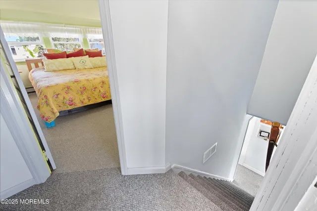 a bed room with a bed mirror and a window