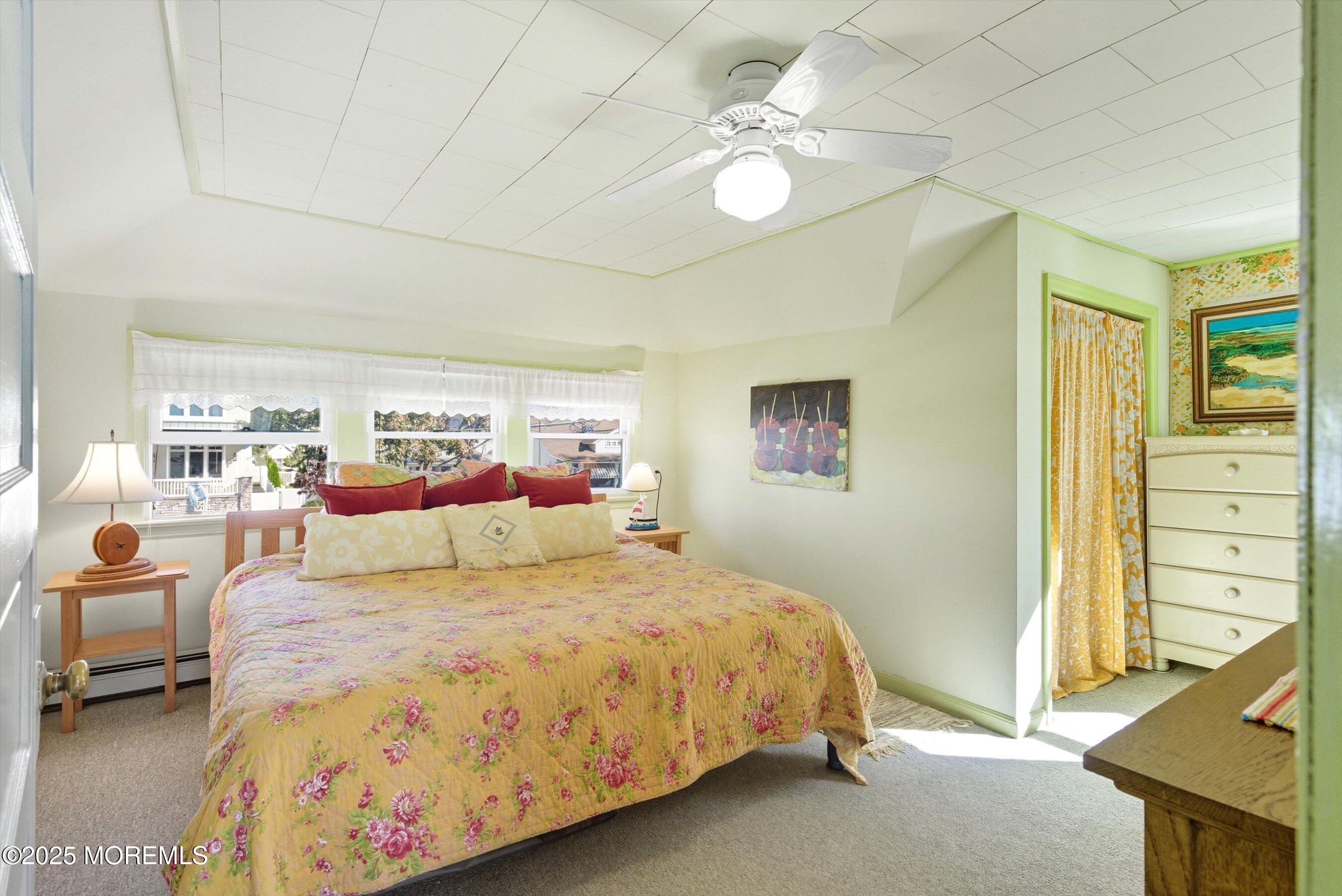 425 Washington Avenue Avon-by-the-Sea, NJ 07717 - Photo 21 of 41 a bed room with a bed mirror and a window