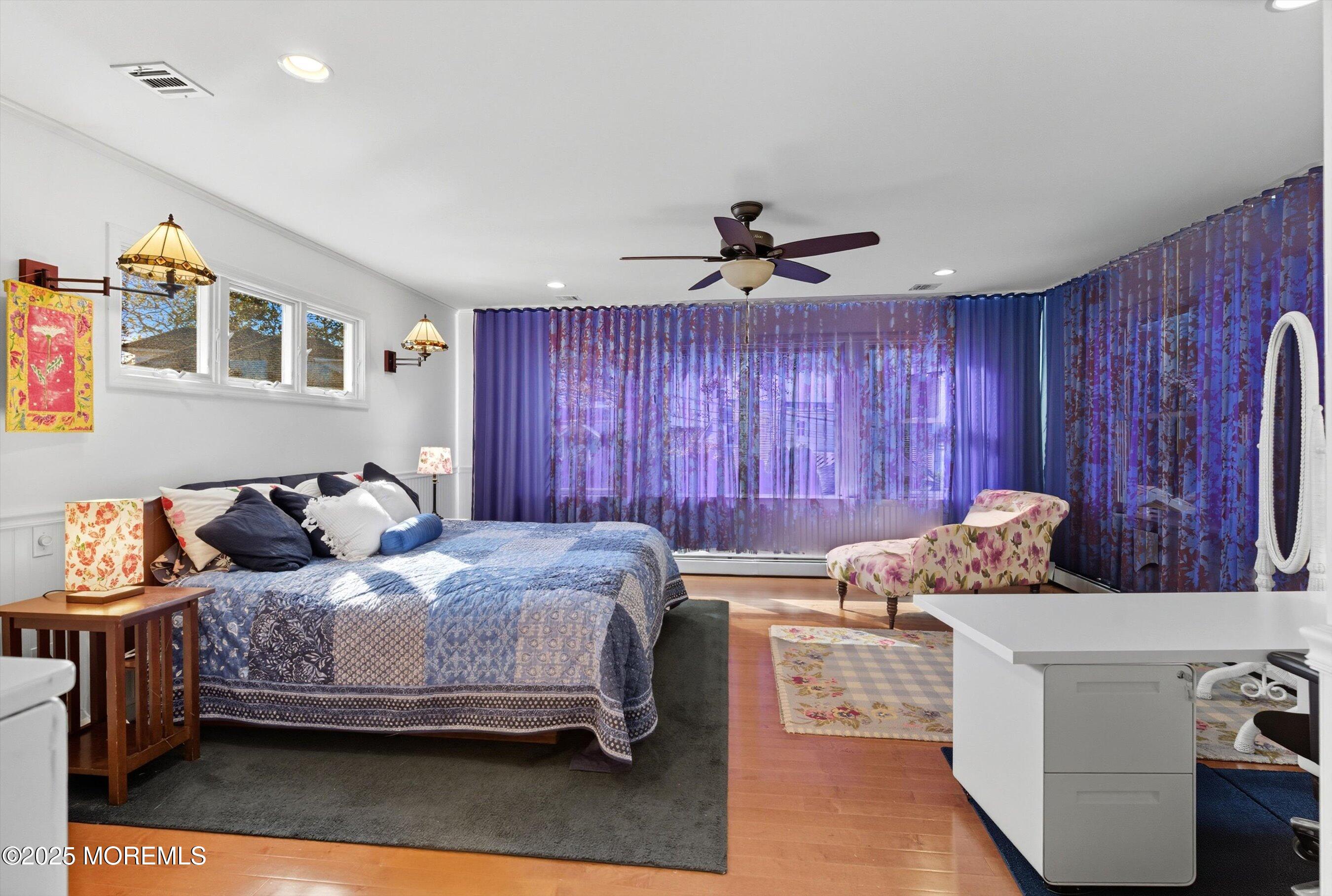 425 Washington Avenue Avon-by-the-Sea, NJ 07717 - Photo 26 of 41 a bedroom with a bed and wooden floor