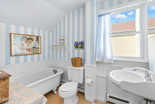 a bathroom with a toilet a sink and a bathtub