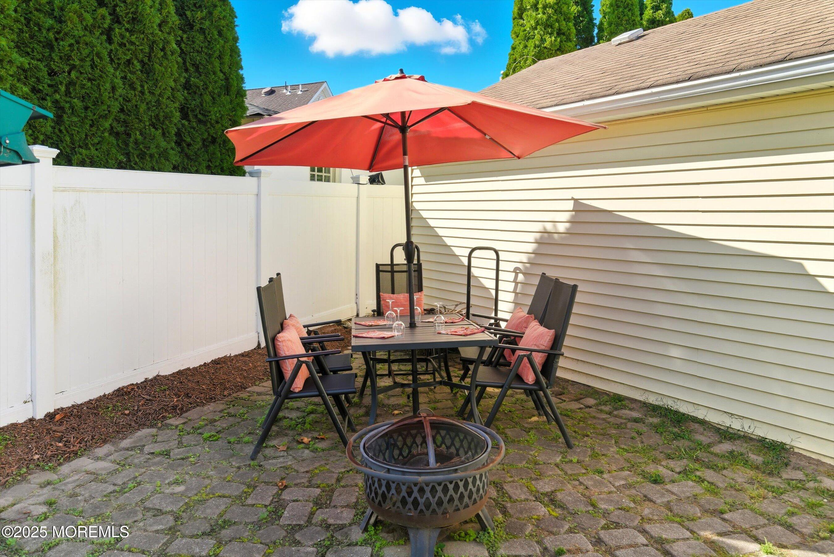 425 Washington Avenue Avon-by-the-Sea, NJ 07717 - Photo 32 of 41 a view of a table and chairs in backyard