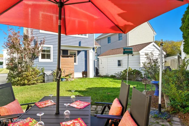 a view of a porch with furniture and a yard