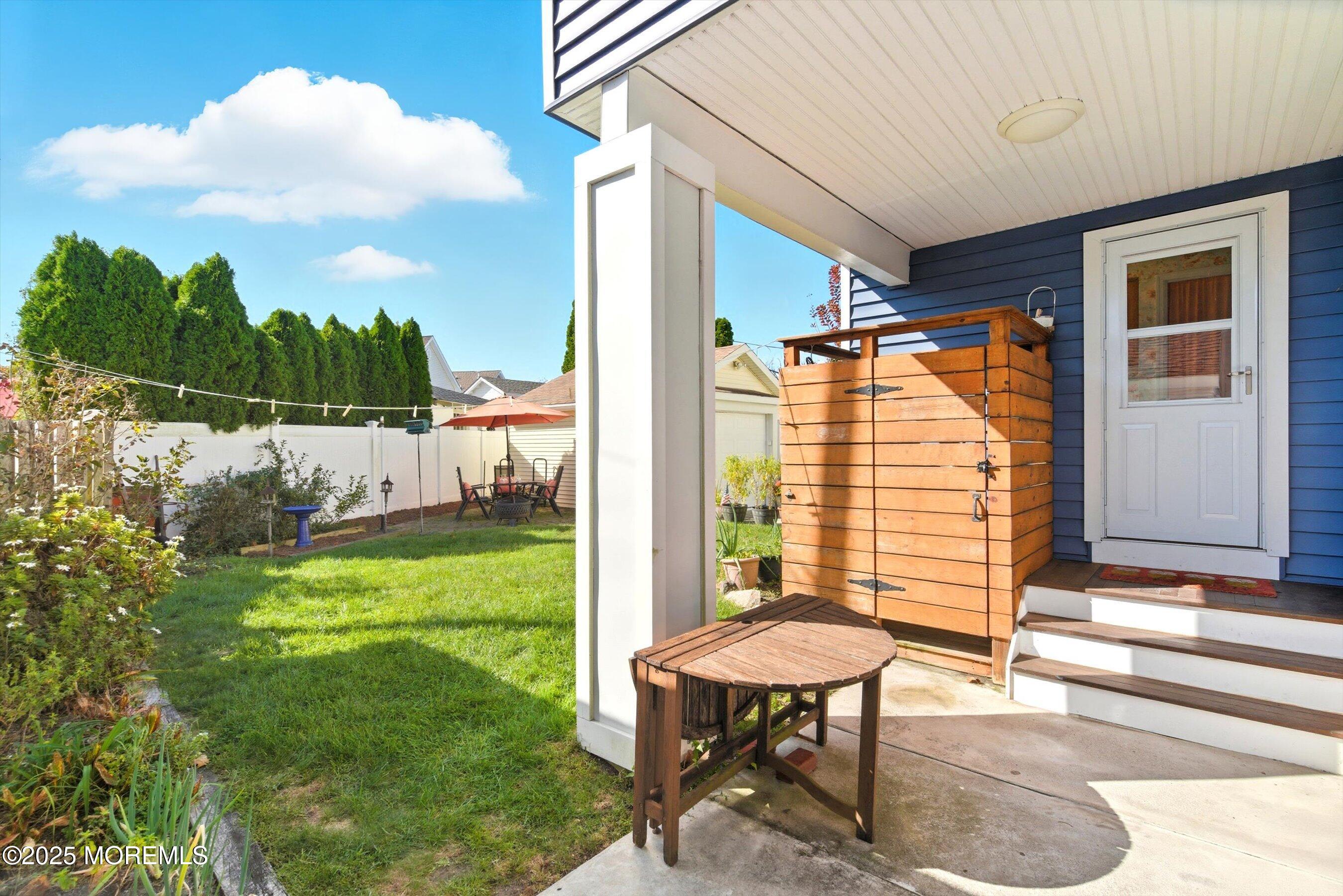 425 Washington Avenue Avon-by-the-Sea, NJ 07717 - Photo 34 of 41 a view of a porch with furniture and a yard