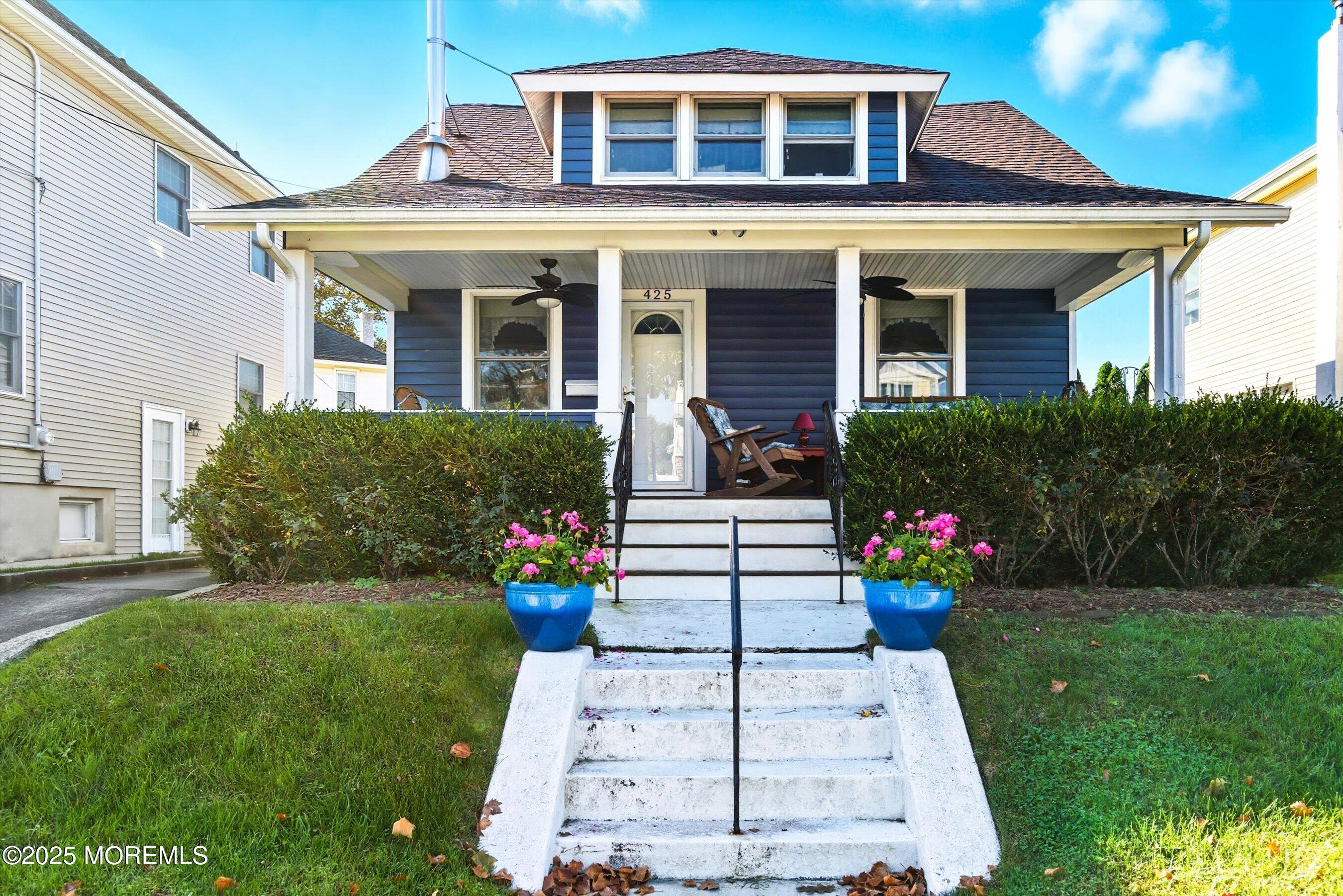 425 Washington Avenue Avon-by-the-Sea, NJ 07717 - Photo 5 of 41 a front view of a house with a garden