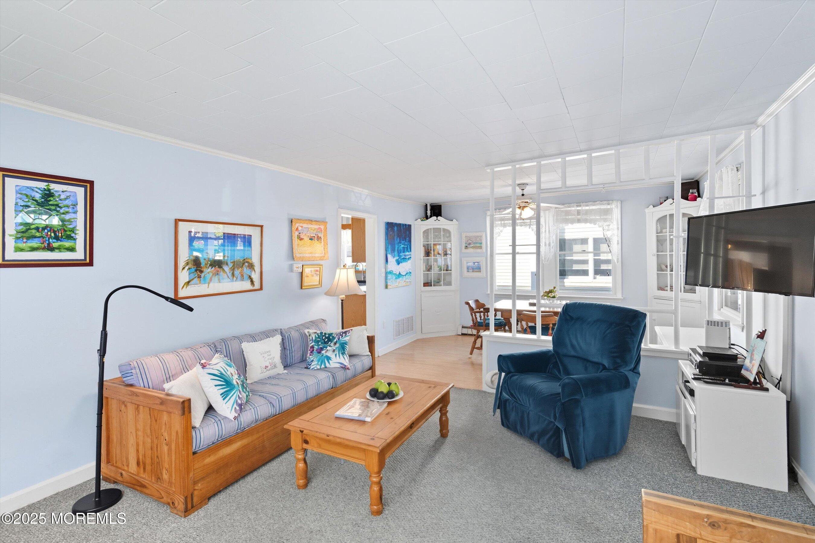 425 Washington Avenue Avon-by-the-Sea, NJ 07717 - Photo 10 of 41 a living room with furniture and a flat screen tv
