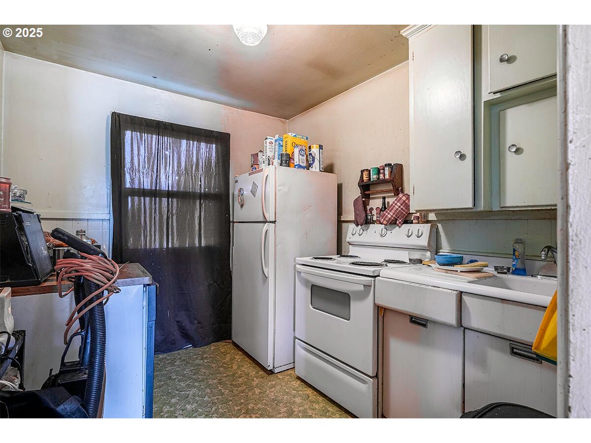 166 Reager Street Medford, OR 97501 - Photo 27 of 43 a kitchen with a refrigerator and a stove top oven