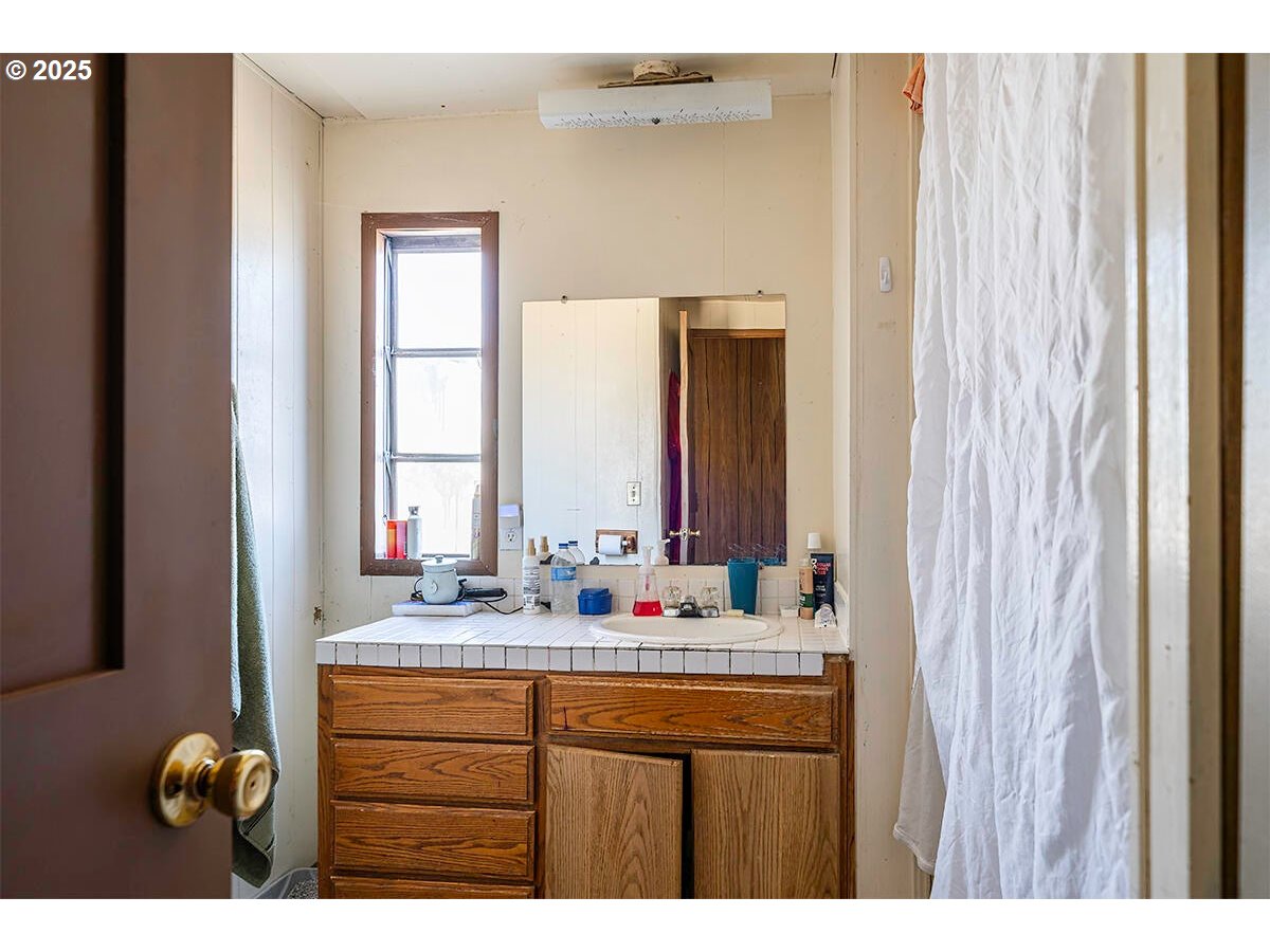 166 Reager Street Medford, OR 97501 - Photo 39 of 43 a bathroom with a sink and a mirror
