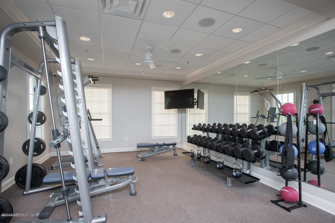 152 Oleta Way St. Augustine, FL 32095 - Photo 2 of 7 a living room with gym equipment and a flat screen tv