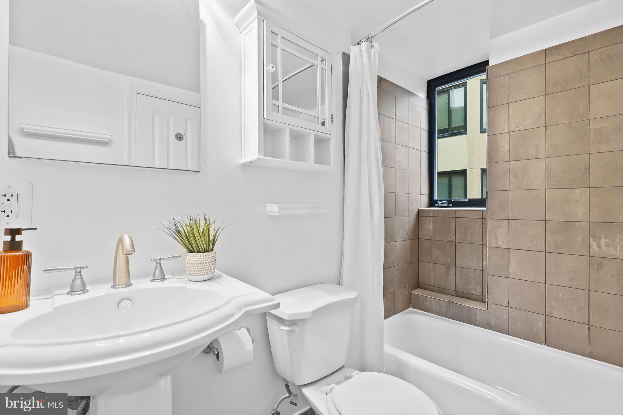1701 16th Street Northwest, Unit 706 Washington, DC 20009 - Photo 11 of 29 a bathroom with a sink toilet and shower