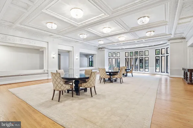 a view of a dining room with furniture and a chandelier