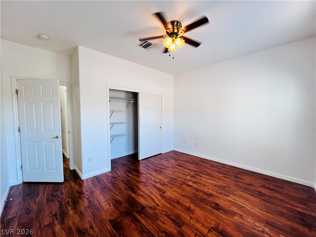 3047 Hickory Valley Road Henderson, NV 89052 - Photo 22 of 33 Lustrous hardwood-style flooring extends across this well-lit room, ideal for comfortable living.