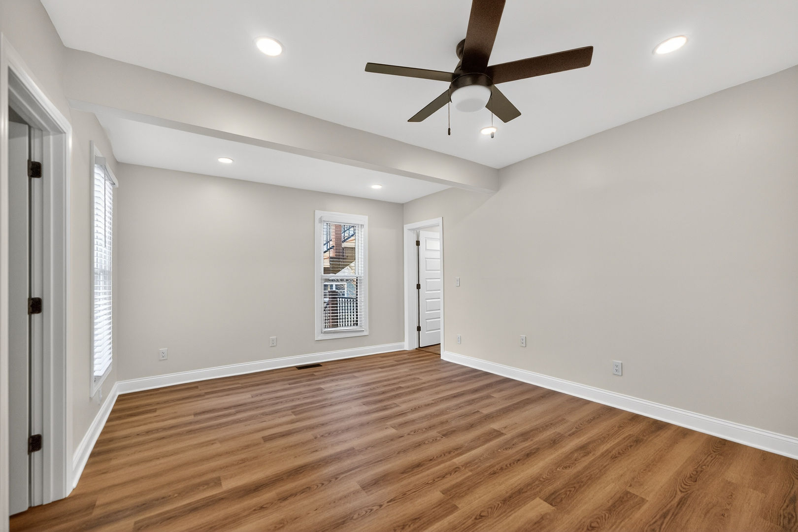 305 West Exchange Street, Unit A Sycamore, IL 60178 - Photo 11 of 27 wooden floor in an empty room with a window