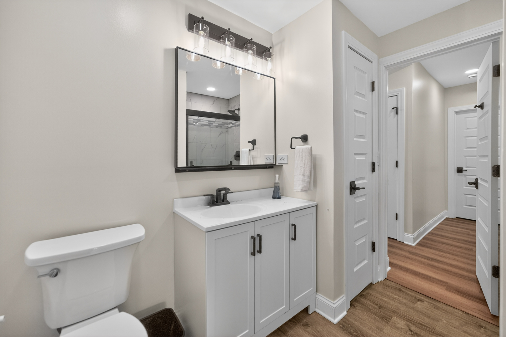 305 West Exchange Street, Unit A Sycamore, IL 60178 - Photo 14 of 27 a bathroom with a toilet a sink and mirror