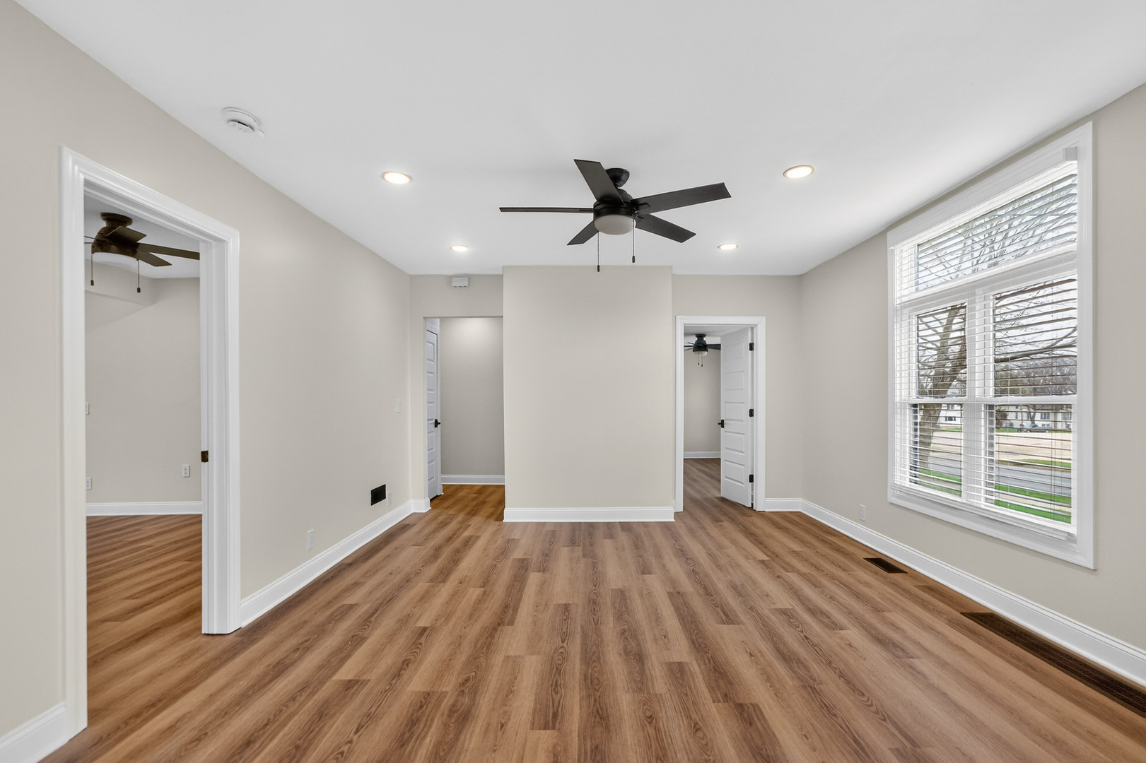 305 West Exchange Street, Unit A Sycamore, IL 60178 - Photo 17 of 27 a view of an empty room with a window and wooden floor
