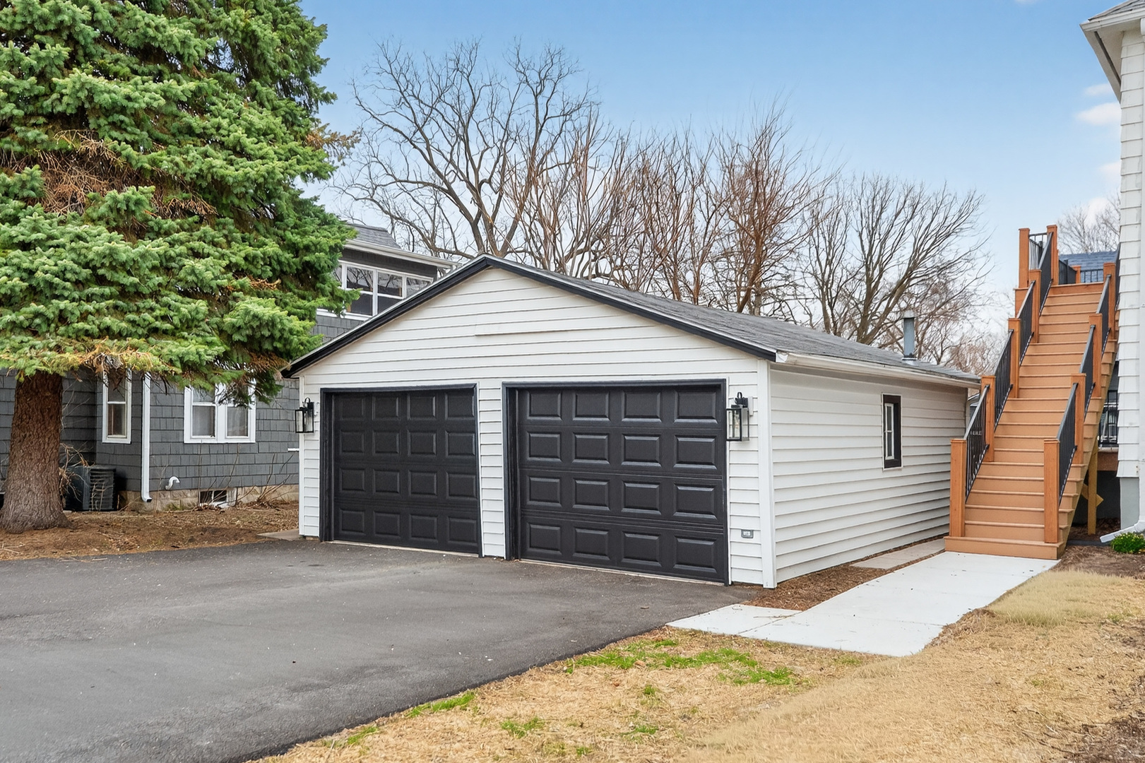 305 West Exchange Street, Unit A Sycamore, IL 60178 - Photo 23 of 27 a front view of a house with a yard and garage