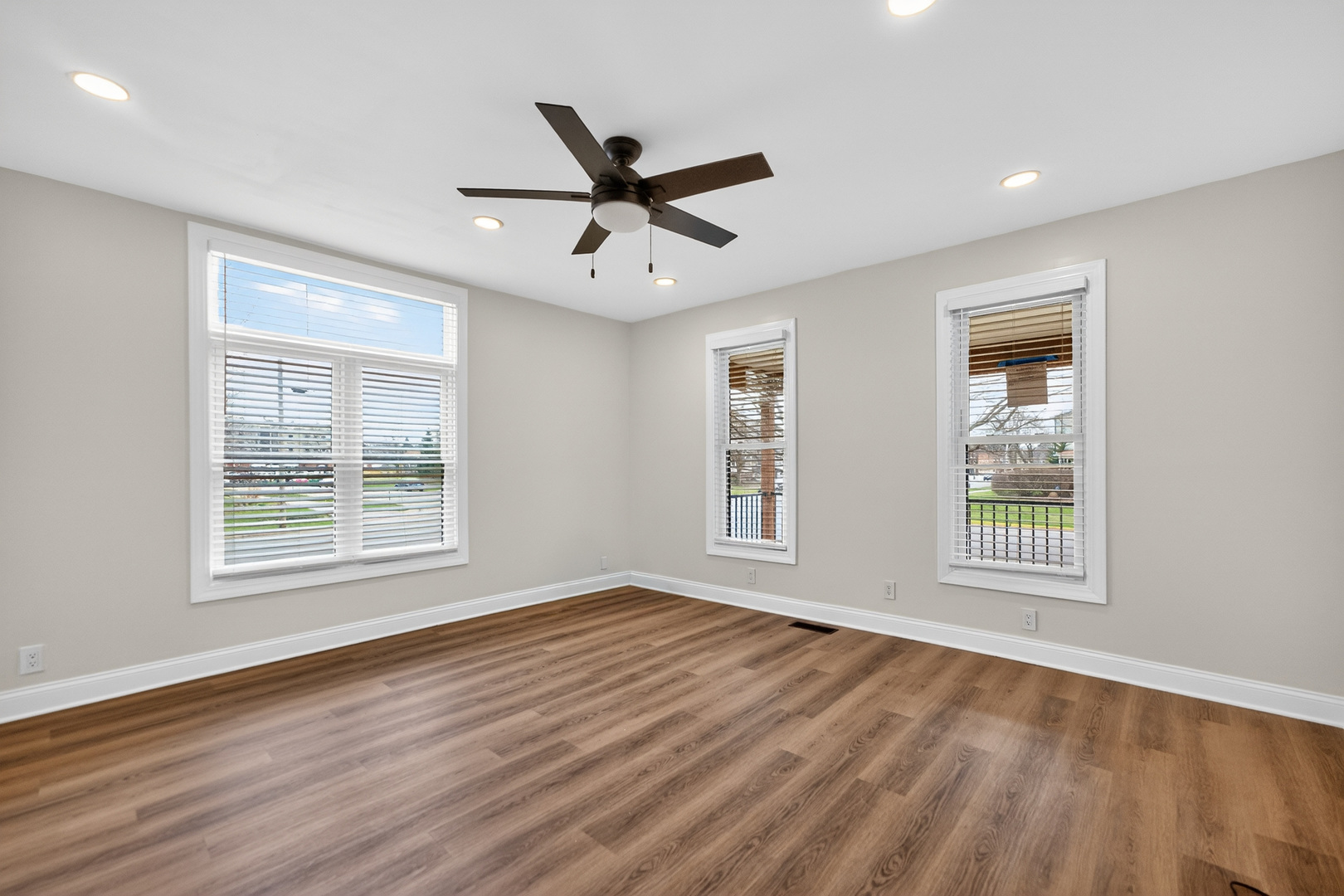 305 West Exchange Street, Unit A Sycamore, IL 60178 - Photo 6 of 27 a view of an empty room with wooden floor and a window