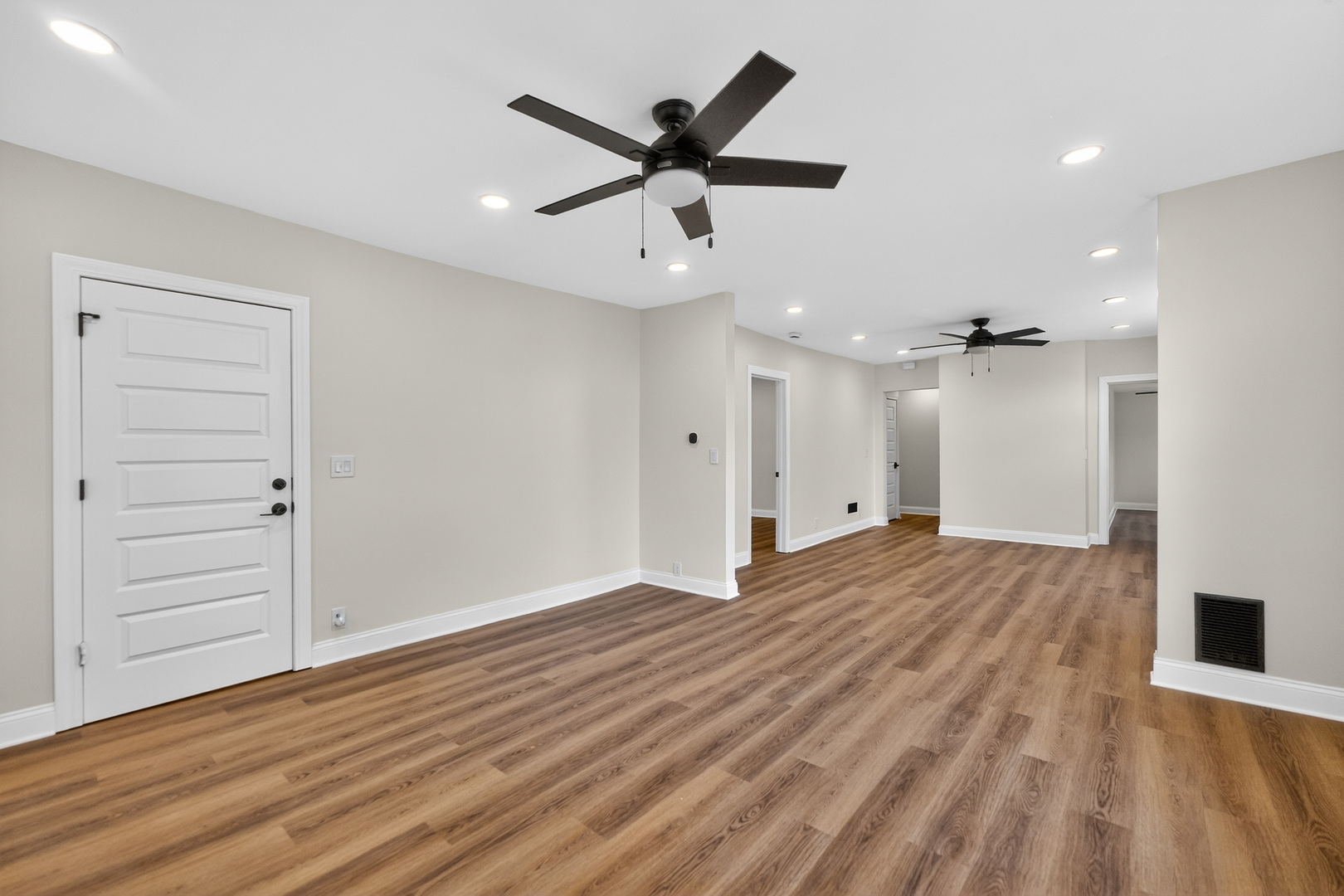 305 West Exchange Street, Unit A Sycamore, IL 60178 - Photo 8 of 27 an empty room with wooden floor ceiling fan and windows